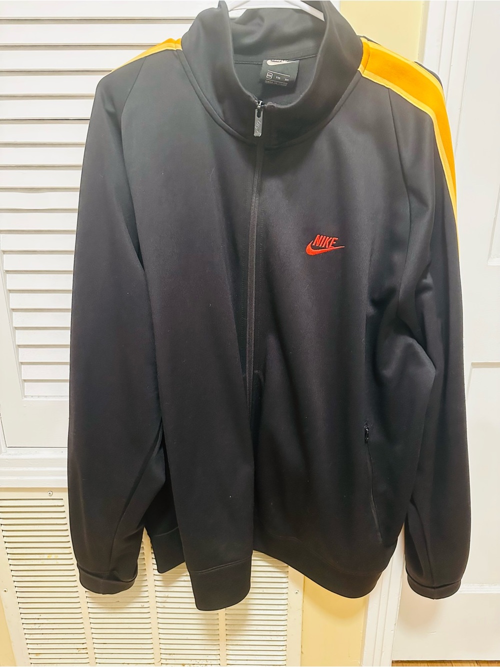 Nike Black Track Jacket with Yellow Shoulder Stripes and Red Logo